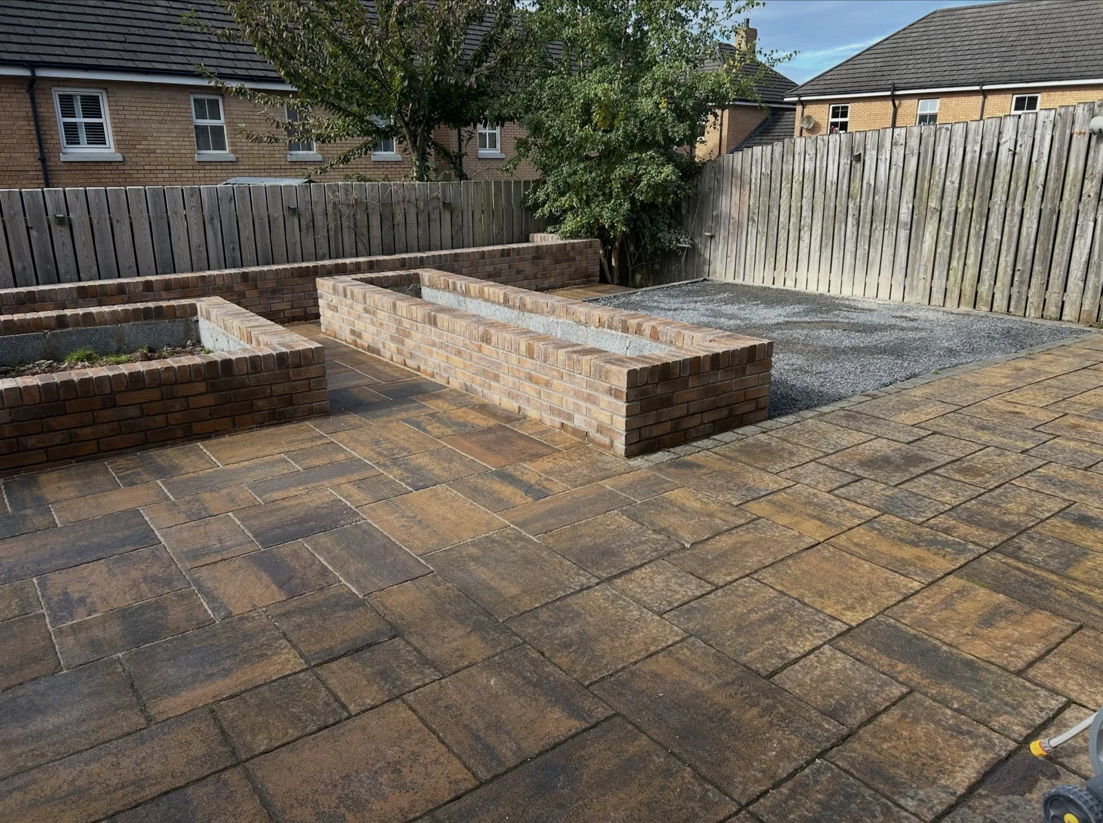 Tobermore paving and raised brick flowerbeds by S.E. Bricklaying and Paving